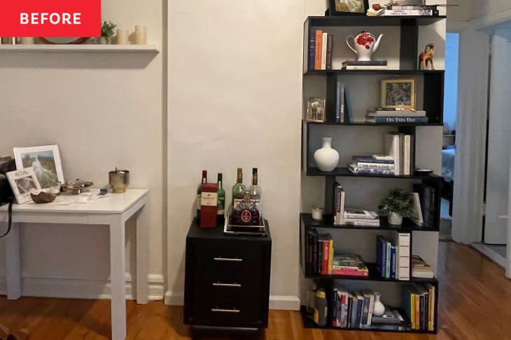 Black IKEA Billy shelves in a room, before makeover