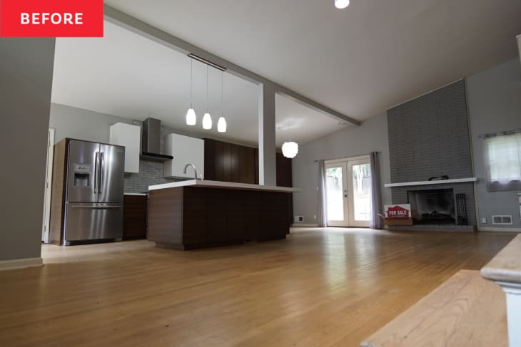 Before: Open kitchen/living area with one wall of cabinets and an island, plus a gray brick fireplace