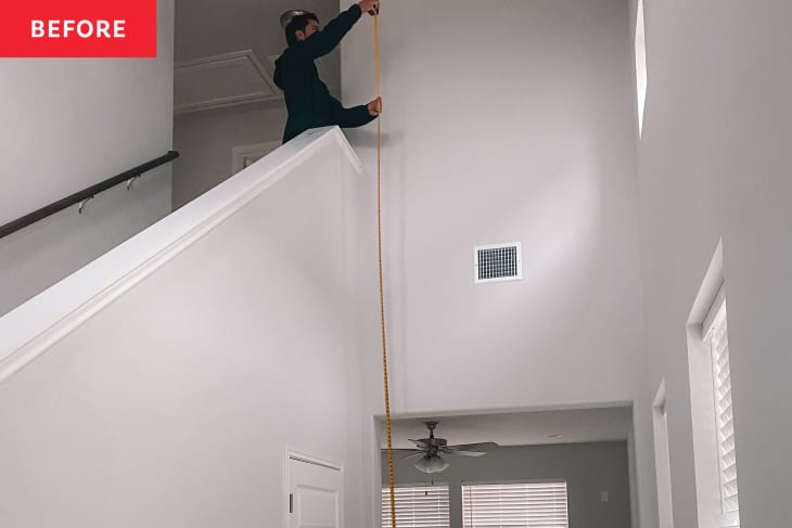 Someone measuring wall before installing art wall.