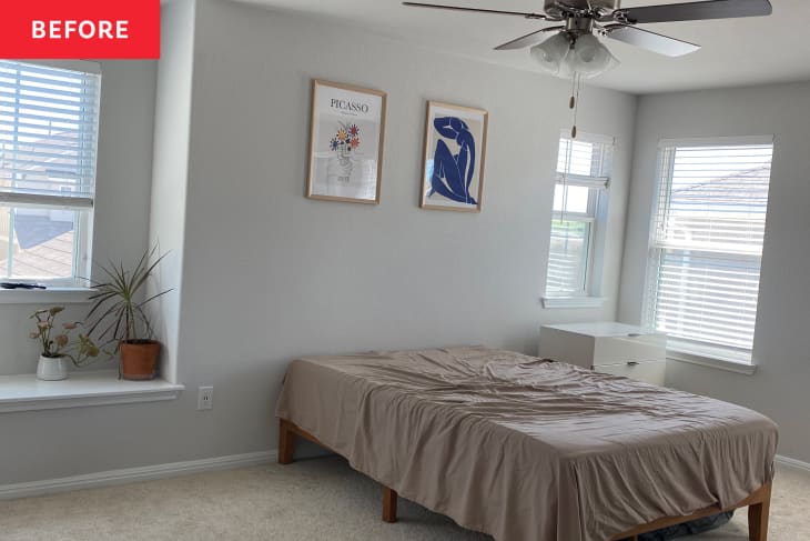 Bedroom with two posters on wall before renovation.