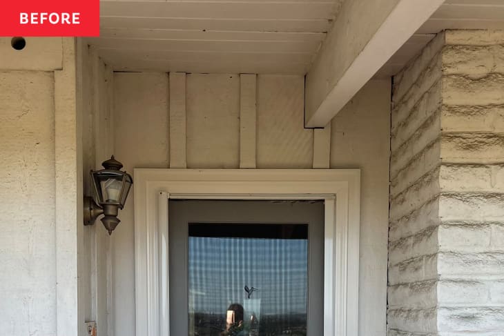 front door before renovation. White door with white paint around