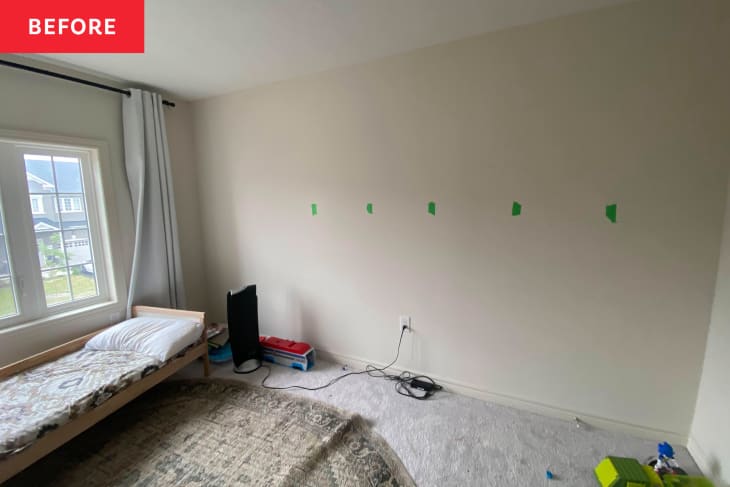 Nursery with painters tape on wall before renovation.