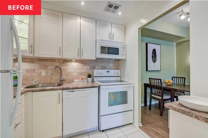 Kitchen before remodel/makeover. large white tile floor, silver hardware with outdated silhouettes, pink hued stone look wall tiles and counters