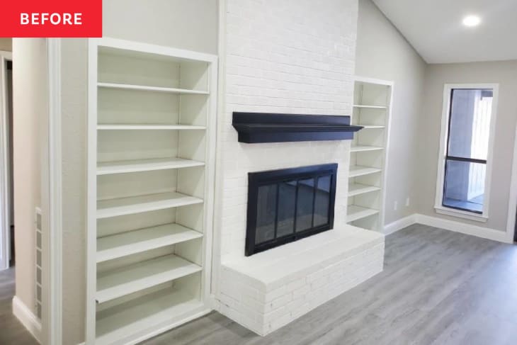 Empty living room with white walls, fireplace and built-in shelves