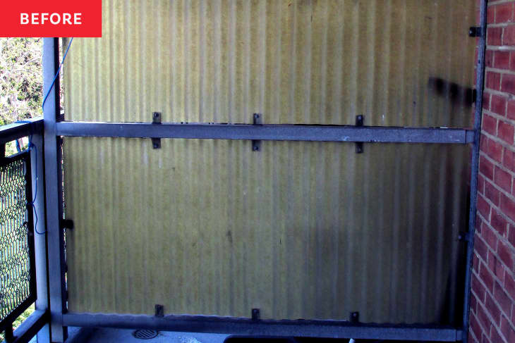 plain corrugated metal "wall" or partition on balcony before renovation/makeover