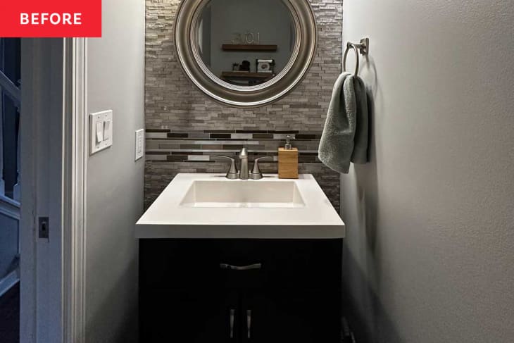 bathroom before makeover: gray walls, gray tile, brushed stainless steel hardware finishes