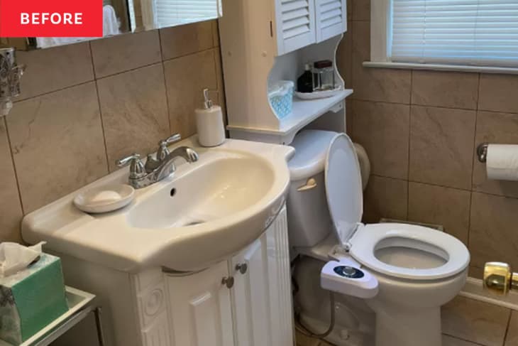 Bathroom before renovation: brown large tile walls and floor, outdated cabinets
