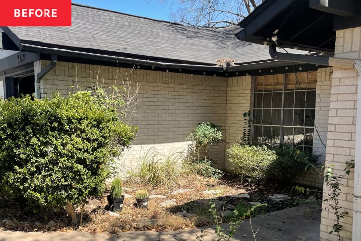Front exterior (curb appeal) of home before makeover: yard with dry brush, plants, sand colored brick walls, some cement