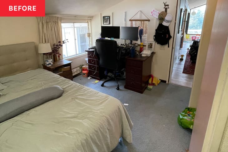 Bedroom before renovation/makeover into nursery. White walls, gray carpet, TV, bed, somewhat messy and disorganized