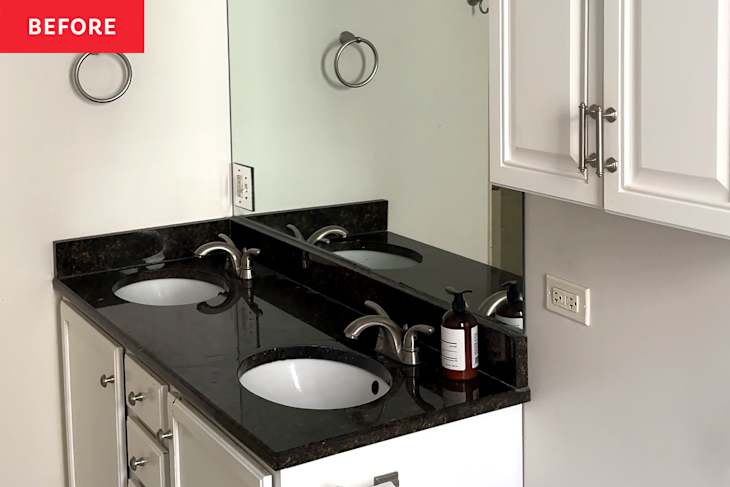 Black vanity top in bathroom before renovation.