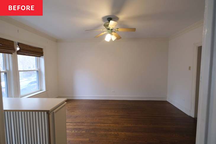 Empty room with hardwood floors, ceiling fan, and two windows with bamboo shades.