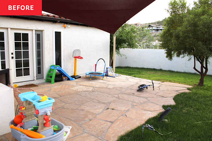 Patio area with a stone floor, children's toys, a small slide, a trampoline, and a grassy yard.
