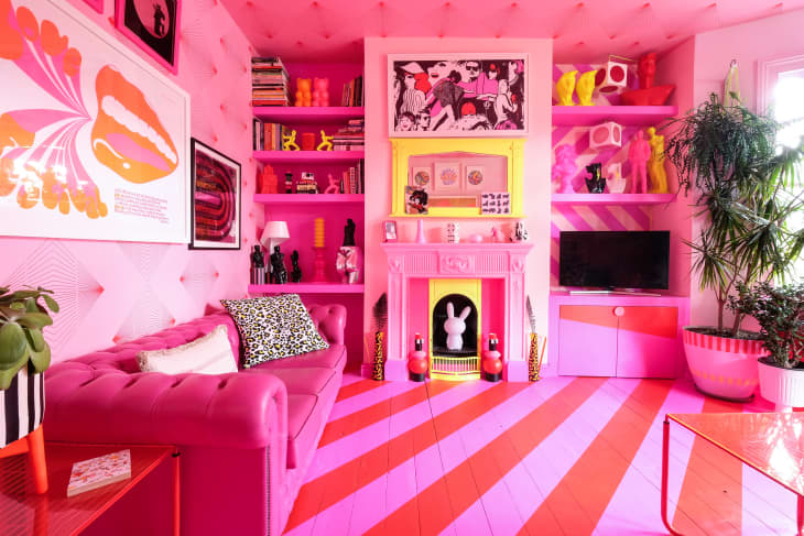 bright pink living room features dramatic pink and red striped flooring