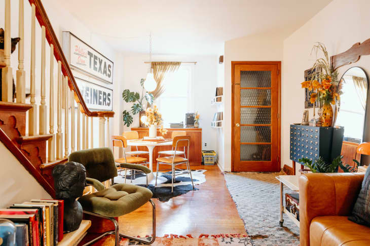 White tulip table is seen in view of dining area from living room.