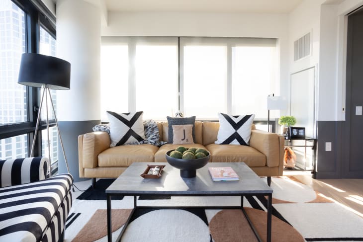 Modern living room with beige leather sofa, graphic black and white accents