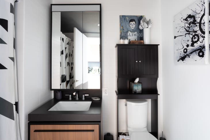 Bathroom with black and white accents, detail of sink and black cabinet