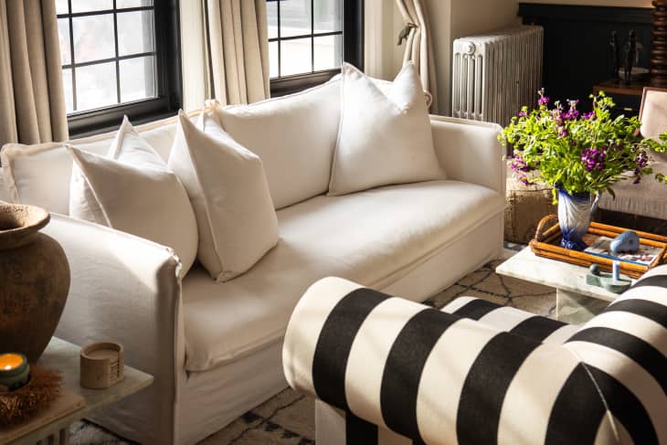 Living room detail of white sofa and black and white striped chair