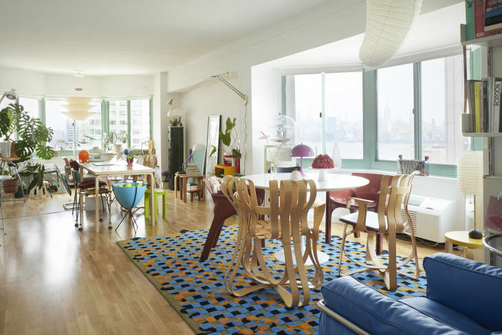 Living room with large windows and two tables.