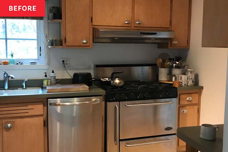 A compact kitchen with wooden cabinets, stainless steel appliances, a sink, and a cutting board on the counter.