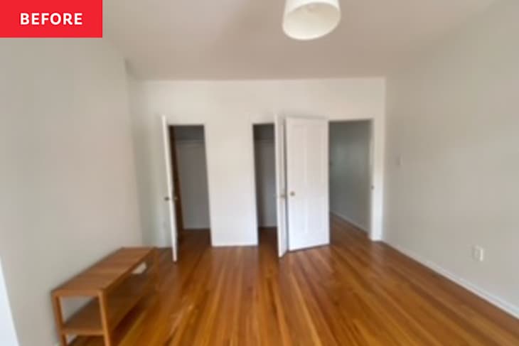 A bright room with hardwood floors, featuring three open closet doors and a wooden console table.