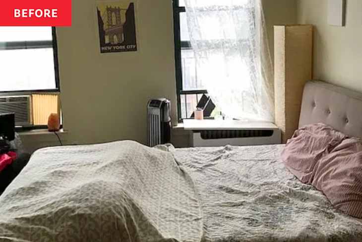 A bedroom with a bed covered in a patterned blanket, pink pillows, and a window with sheer curtains.