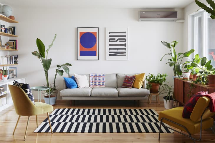 a modern living room with colorful throw pillows and artwork