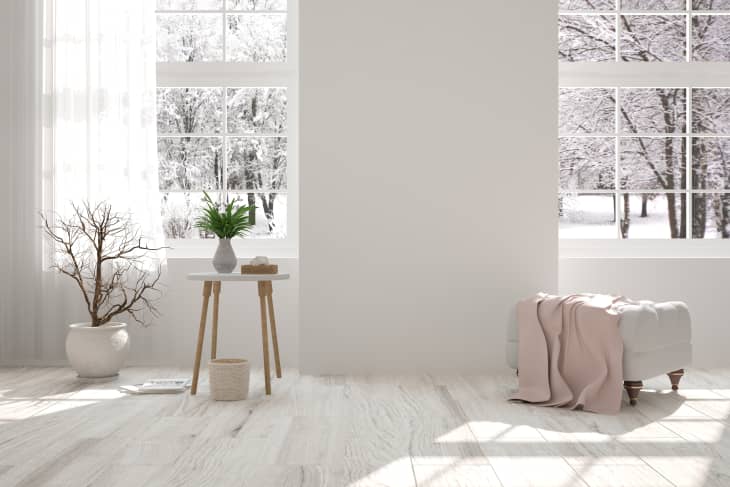White room with chair and winter landscape in window. Scandinavian interior design. 3D illustration
