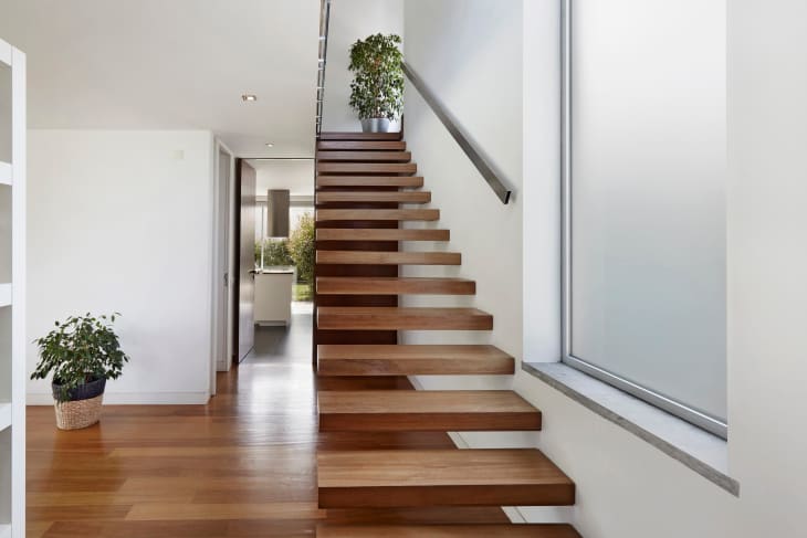 Floating staircase in home with plants