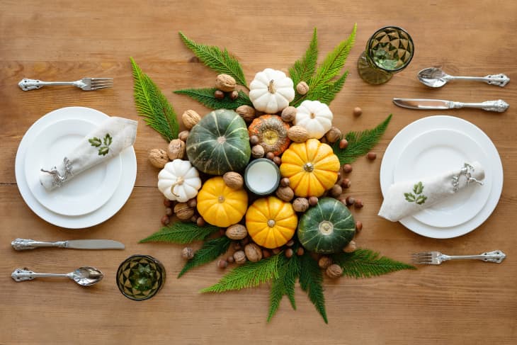Thanksgiving tablescape set for two with mini pumpkins and plates