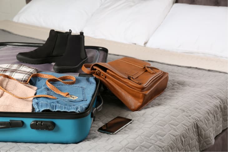 Suitcase with things clothing for travelling Vector Image