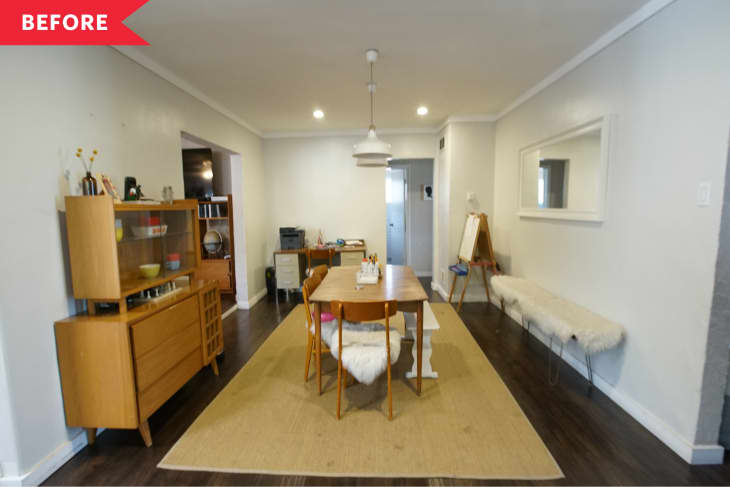Dining room with wooden table, chairs, sideboard, pendant light, and a mirror on the wall. Beige rug and fluffy bench.