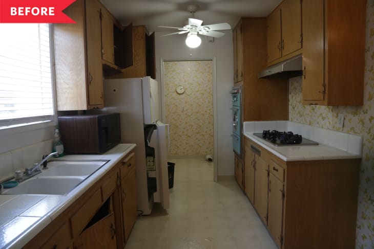 Before: Dated kitchen with yellow butterfly wallpaper, wooden cabinets, and white tile counters