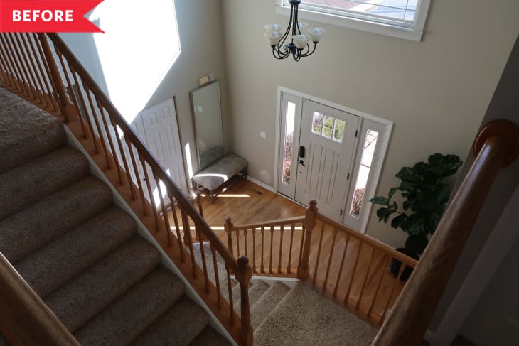 Before: View of front door from dim stairwell with carpeting