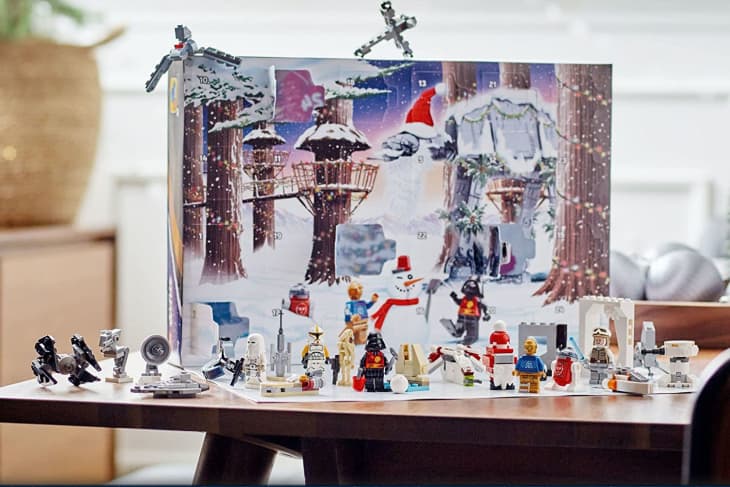 Star Wars-themed advent calendar with various LEGO figures and mini builds on a table.