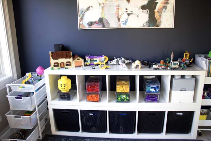 Legos are organized on shelves.