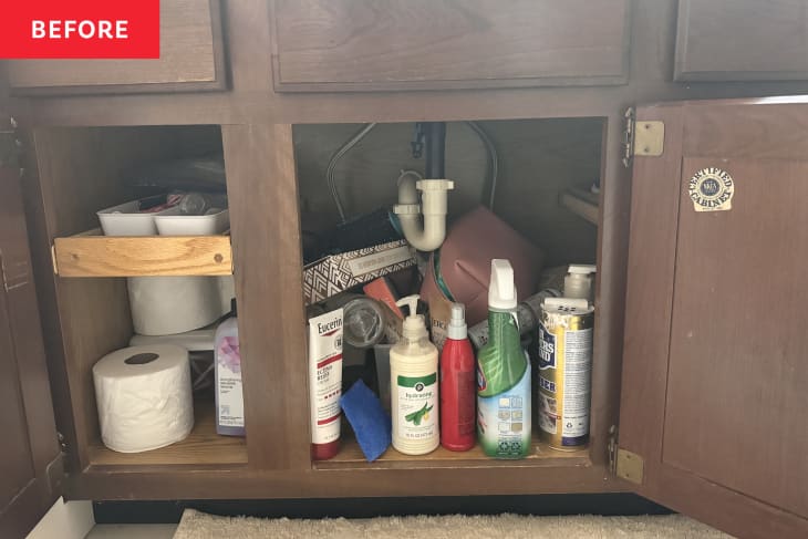 under sink cabinet with bottles and box scattered