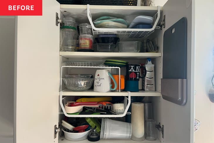 Messy unorganized cabinet with some shelving