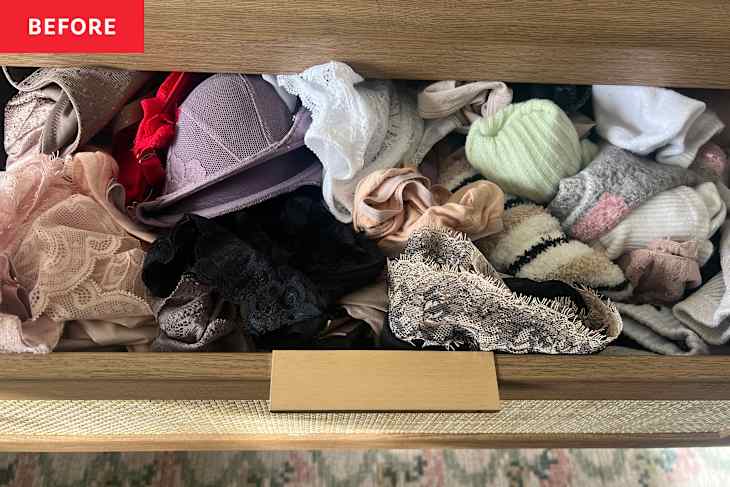 A cluttered drawer filled with various bras, lace items, and socks in different colors and textures.