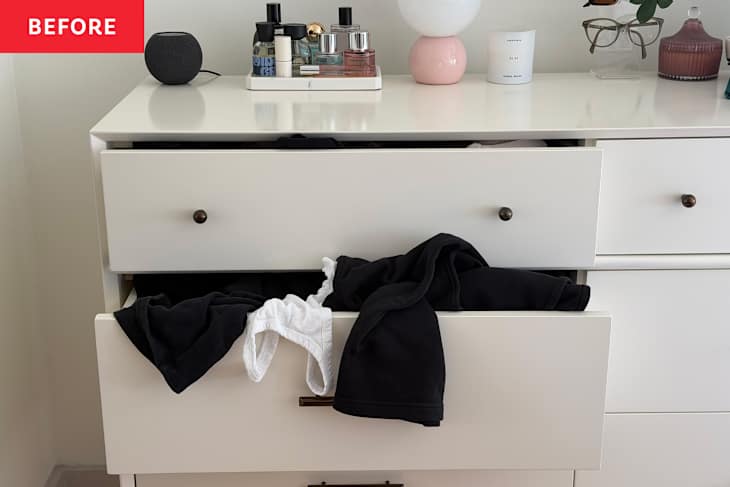 Clothes sticking out of drawer.