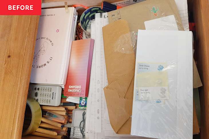Notebooks in messy junk drawer.