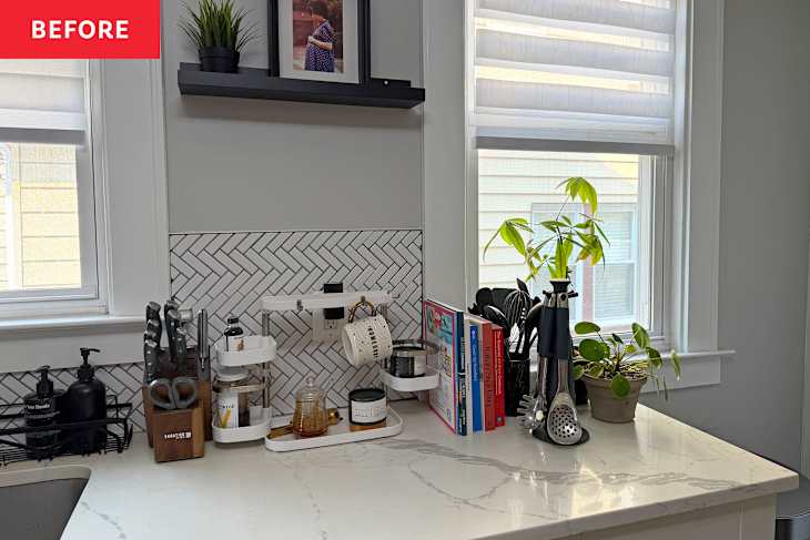 Kitchen countertop with a knife block, utensils, cookbooks, a plant, and a spice organizer.