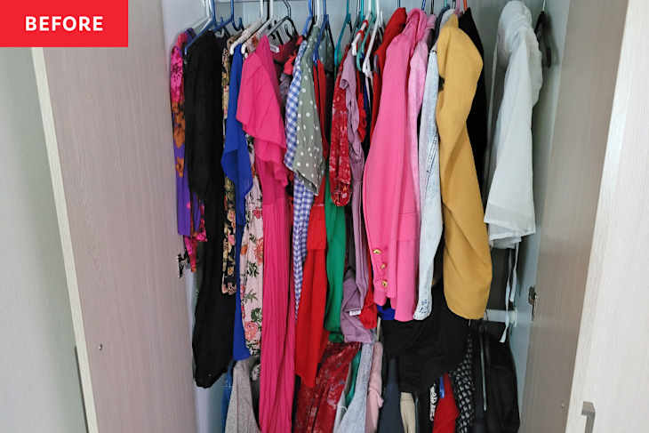A cluttered wardrobe filled with various colorful clothes on hangers, including dresses, blouses, and jackets.