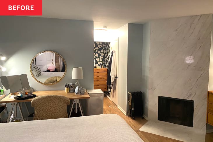 Bedroom with small desk and mirror next to fireplace before adding Ikea Pax vanity.