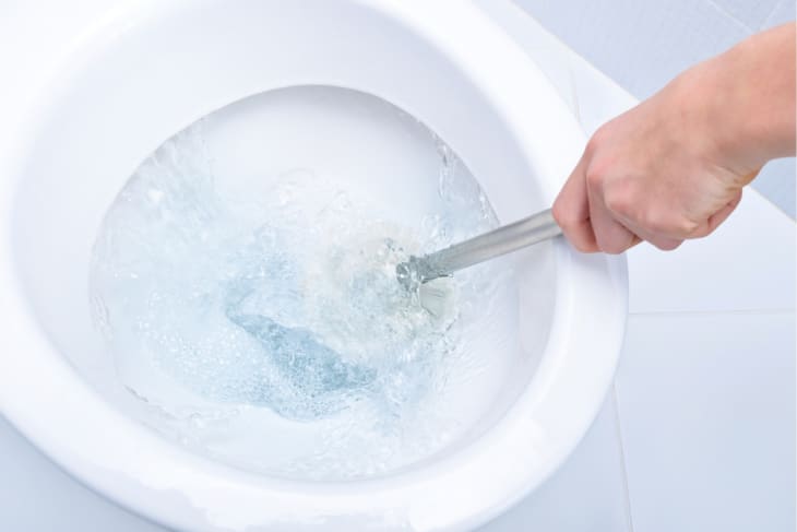 Cleaning a toilet with a toilet brush