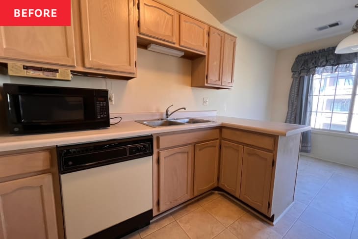 kitchen before home staging: outdated black appliances, outdated wood cabinets, tile floor