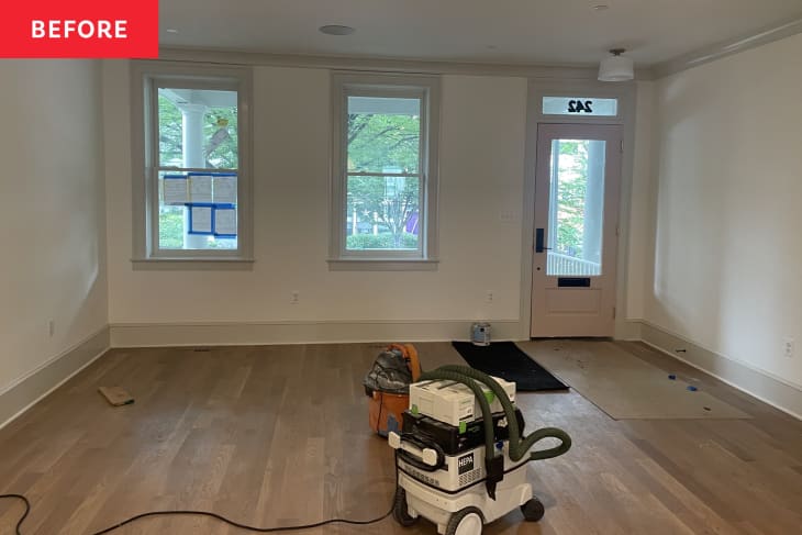 wood floors, industrial vac, front door, windows, tan molding, white walls, empty room