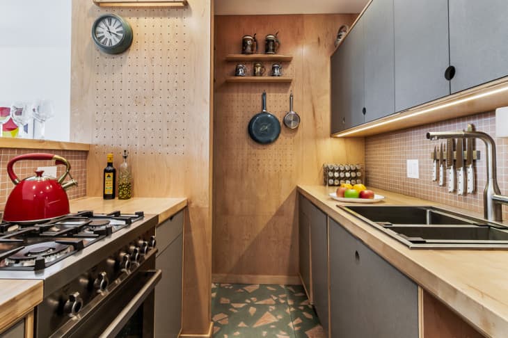 kitchen with pegboard walls, tile backsplash, and butcher block countertops