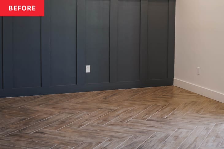 Empty white bedroom with dark gray wainscoting on one wall