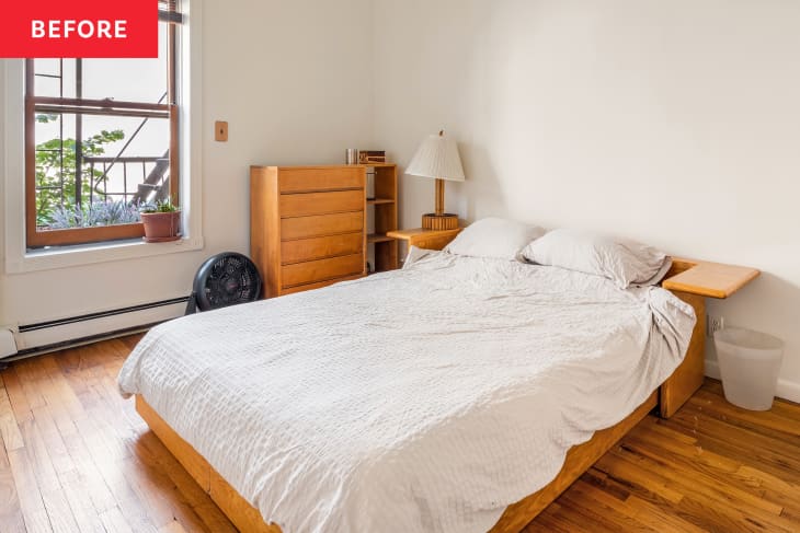White bedroom with dresser, bed, and wood flooring.