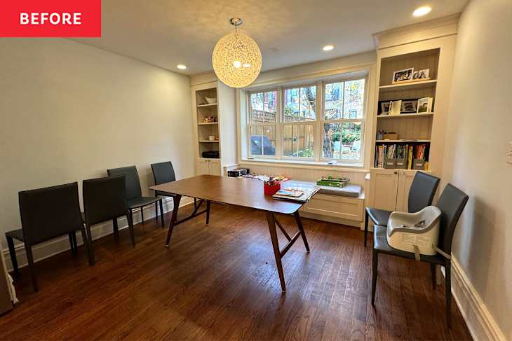 Dining table in room with built in shelves.